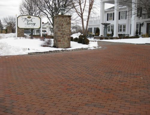 Brick Driveway with snow and columns