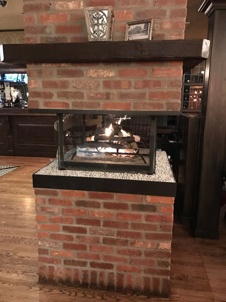 thin brick fireplace in open room