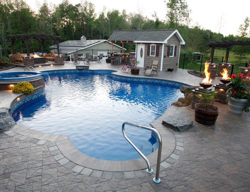 Stone patio with pool, hot tub, grilling are and bonfire